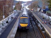 Heading north,170423 eases slowly past the site of the goods train derailment at Carrbridge.The damage to the platforms is visible and the damaged track in the loop has been lifted.<br><br>[John Gray 19/01/2010]