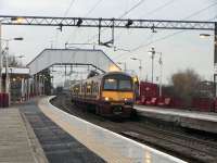 Although long after sunrise, full daylight seemed a long time coming at Clydebank on a dull 20 January. Meantime 320 302 prepared to leave with one of the four trains an hour on the short hop to Dalmuir. Class 320s can't use the Argyle Line, so this service had stayed north of the Clyde - from Springburn in fact.<br>
<br><br>[David Panton 20/01/2010]