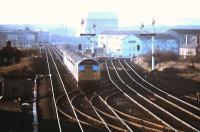 View west at Saughton Junction in late 1975 following resignalling. The semaphore arms have been removed but the old signal posts still stand, the Edinburgh - Glasgow shuttles are in the hands of type 2s, with one at each end operating on the push-pull principle and the large gasometer on Sighthill Industrial Estate dominates the horizon (not far south of what is now Edinburgh Park station).<br><br>[Neil McWilliam //1975]