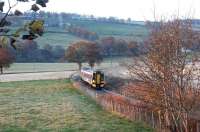 The northern approach to Beauly on a chilly morning in the Autumn of 2003, with a 158 off the Kyle line slowing to call at the station.<br><br>[John Furnevel 23/11/2003]