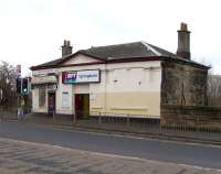 Waves of modernisation have swept away most station buildings of <br>
character in suburban Glasgow, but Springburn's ticket office on <br>
workaday Atlas Road seems to be original. The lower storey meets platform 2 at an angle but it is not used and platforms are accessed by footbridge.<br><br>[David Panton 20/01/2010]