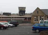 Coaling towers were once a distinctive skyline feature in many places but are very rare now. The tower at Carnforth is a concrete post-war structure and survives in the West Coast Railway depot although it is no longer operational. It is seen here from Carnforth station car park with the depot water tower alongside. The old main line platforms and the subway entrance can be seen to the left of the station building, which now houses a travel centre booking office and small businesses.<br><br>[Mark Bartlett 26/01/2010]