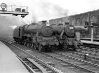 Jubilee 45593 <I>Kolhapur</I> stands alongside Black 5 44750 on the middle roads at the south end of Carlisle on 5 July 1958 waiting to take over southbound trains.<br><br>[Robin Barbour Collection (Courtesy Bruce McCartney) 05/07/1958]