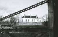 The former GNSR station at Longmorn viewed from the nearby distillery in late 1980. The internal distillery lines had been left in place when BR closed the Elgin - Rothes route and were well worn with rotten sleepers (I understand it was second hand GNSR rail from the 1880's.) The management eventually decided to scrap the rail, tarmac the trackbed and buy a lorry. They offered the whole internal system to the Strathspey Railway, rail, sleepers, points, loco and wagons. In consequence many of us spent some time on site readying materials for loading onto lorries. So far as I know much of it will still be at Boat of Garten.<br>
<br><br>[Peter Todd 22/11/1980]