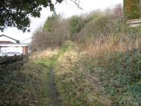 Looking westwards up the incline back towards the viaduct [see image 17374].The line curves sharply to the right whenit reaches the trees in the middle distance. The 1894NBR alignmentis off to the leftbeyond the houses at a slightly lower level. The 1834 alignment to Charlestown Harbour, which involved an incline with a stationery engine,isabout 50 yards behind the photographer.<br>
<br><br>[Mark Poustie 24/01/2010]