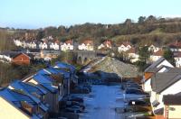 A rather distant view of the isolated railway relic that is the blue brick viaduct over the Glen Water in Darvel. View west in January 2010 from the remaining end of the embankment a quarter of a mile away to the east. As can be seen, modern housing has replaced the railway embankment on both sides of the bridge.<br><br>[Robert Blane 30/01/2010]