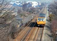 58040 waits amongst the shrubbery on the left of the photograph for permission to leave the British Oak Disposal Point exchange sidings on 13 March 1993 as Pacer no 142079 passes with a service for Sheffield.<br><br>[David Pesterfield 13/03/1993]