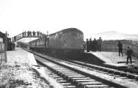 The Hills of Cromdale provide a snowy backcloth for a photostop at Grantown-on-Spey East on the final Speyside passenger train on 2nd November 1968.<br>
<br><br>[David Spaven 02/11/1968]