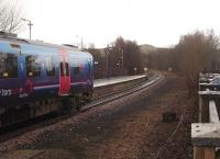 An Oxenholme service, formed by TPE 185134, waits to leave the Windermere branch terminus. The old station building and former railway land on either side of the basic station have been sold for retail development but for a 1960s view from the same spot, before the platform was extended, [see image 24108].<br><br>[Mark Bartlett 02/02/2010]