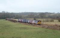 150205, on a Leeds to Morecambe service, leaves Wennington and heads for Melling tunnel and Carnforth. This view was taken from the nearby bridge over the closed Lune Valley line [See image 27099] that swings south west at this point as the Carnforth line turns north west. <br><br>[Mark Bartlett 04/02/2010]