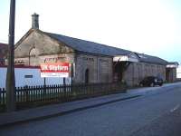 The former railway goods shed at Ashbourne in December 2009. Now surrounded by major new developments all around but still in use with a new company sign at the south west corner of the building.<br><br>[David Pesterfield 10/12/2009]