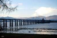 'The other Forth Bridge', opened by the Alloa Railway in 1885, photographed looking north from Throsk towards Alloa and the Ochil Hills in 1966. The central 'swing' section of the bridge, incorporating a signal box mounted above the line, can be clearly seen. The last scheduled passenger train crossed the bridge in 1968 and the last freight two years later. Removal of the deck and superstructure took place during 1971, but the piers remain in the Forth to this day [see image 8843]<br>
<br><br>[Frank Spaven Collection (Courtesy David Spaven) //1966]