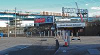 The Port Eglinton Viaduct of the M74 Extension towers over West Street station and the Glasgow-Paisley line. For a similar view before the viaduct was built [see image 10477].<br><br>[Ewan Crawford 11/02/2010]