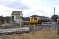 A DMU eastbound at Kinloss level crossing on 31 March 1979<br>
<br><br>[Peter Todd 31/03/1979]