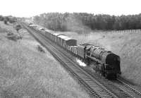 A northbound mixed freight runs through Braidwood behind a BR class 9F 2-10-0 in July 1966.<br><br>[Colin Miller 15/07/1966]