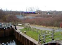 The staircase locks of the Lancaster Canal's Ribble Link, opened in 2002 and therefore one of the newest stretches of canal in the country, are passed by a Blackpool North to Manchester Airport TPE 185 unit. At the foot of the locks, boats join the Savick Brook and turn sharp right to pass under the railway. [See image 27564]<br><br>[Mark Bartlett 08/02/2010]