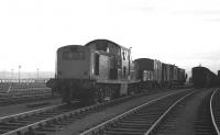 A brake van carrying members of Edinburgh University Railway Society forms part of a the 14.58 Millerhill - Royal Elizabeth Yard trip freight standing ready to leave Millerhill for Dalmeny on 5 November 1969 behind Clayton D8612.<br><br>[Bill Jamieson 05/11/1969]