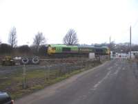 66522 in joint Shanks / Freightliner livery passing west light engine over the level crossing leading to the Bombardier Transportation maintenance depot at Crofton, near Wakefield; the lights of which are just visible over the hedge beyond the locomotive.<br><br>[David Pesterfield 17/02/2010]