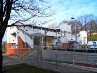 The recently built footbridge at Dalmuir photographed on 17 February.This is a substantial structure linking all 5 platforms and has 3 lifts. The Lanark train on Platform 4 gives an idea of scale. Its solidity and permanence throws into contrast the portakabins which form the ticket window and staff accommodation: far more humble stations than this at least have a ticket office-cum-waiting room!<br><br>[David Panton 17/02/2010]