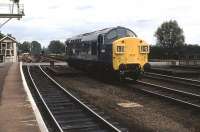 An ex-works English Electric Class 37, No. 6728, runs light engine through Ely in July 1972, perhaps on the way back to Stratford. At this time these engines were the mainstay of the loco hauled London Liverpool St to Kings Lynn services. The Type 3 is just passing the very wide level crossing controlled by Ely North signal box. This loco later became 37028, and was used on West Highland services in the early 1980s. In 1986 it was modified and became 37505 and was used in South Wales, Scotland and France in this quise. Only finally withdrawn in 2007 it was removed from Ayr TMD and later dismantled at EMR Kingsbury. <br><br>[Mark Bartlett /07/1972]