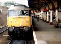 The driver of a class 47 gets a green flag and a stiff neck at Dundee station in April 1987 as he prepares to take out an Aberdeen - Glasgow Queen Street service. <br><br>[John Furnevel 25/04/1987]