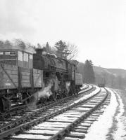 Ivatt 2-6-0 no 43049 takes the Langholm freight away from the town and heads back towards Riddings Junction in the mid 1960s. [See image 26927] <br><br>[Robin Barbour Collection (Courtesy Bruce McCartney) //]