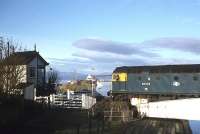 A northbound train hauled by 26034 slows for the token exchange at Clachnaharry in the spring of 1980.<br><br>[Frank Spaven Collection (Courtesy David Spaven) //1980]