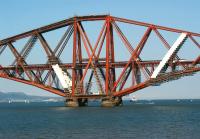 A southbound National Express HST crosses the Forth Bridge on 31 May 2009. The power cars had been rebranded at this stage but the rest of the stock had merely received a white stripe in place of the GNER red.<br><br>[John McIntyre 31/05/2009]
