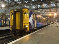 156502 waiting to depart to Whifflet from Glasgow Central platform 4 on 6th February 2010. Now in it's new ScotRail branding, this unit was sent to Utrecht in 1989 when new as BR's representative (in SPT black and orange branding) to celebrate the Dutch Railways 150th anniversary. It went there and back under it's own power, and has since carried commemorative stickers above each cab.   <br><br>[Graham Morgan 06/02/2010]