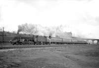 Black 5 4-6-0 no 45185 accelerating towards Kingmoor with a northbound train in the mid 1960s, having just crossed the River Eden and cleared the bridge carrying Etterby Road. The train is passing open ground now occupied by the DRS locomotive depot. [See image 14671]<br><br>[Robin Barbour Collection (Courtesy Bruce McCartney) 30/12/1964]