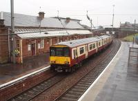 Due to OLE problems at Howwood on 25th February, Ardrossan trains were cancelled and 318261 operated an hourly shuttle between Largs and Kilwinning. The EMU leaves a very wet Saltcoats for the junction.<br><br>[Mark Bartlett 25/02/2010]