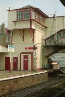 Broughty Ferry signalbox viewed from the southbound platform in 1989 when the box still had another six years of operational life left. The lattice post to the right once carried a lower quadrant signal which was converted to upper quadrant and then relocated below, presumably for a clearer view. At the time of the photograph it was possible to cross between platforms by subway, bridge and level crossing. See news item.<br><br>[Ewan Crawford //1989]