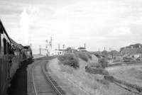 Preserved ex-NBR 4-4-0 no 256 <I>Glen Douglas</I> + J37 no 64624 approaching Tweedmouth from the west with the RCTS (West Riding Branch) <i>Borders Railtour</i> of 9 July 1961. The pair had taken over the railtour at Hawick and, following visits to Greenlaw and Jedburgh, are standing at signals awaiting clearance to enter Tweedmouth station,  where A1 Pacific no 60143 <I>Sir Walter Scott</I> would take over the train for the next leg to Newcastle. Shieldfield Terrace is on the right, with the rear of the train standing alongside Berwick Rangers football ground at Shieldfield Park. The white building beyond the signal gantry is Tweedmouth power box, then under construction.<br><br>[K A Gray 09/07/1961]