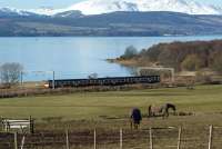 Looking west from Lyleston Farm down towards the River Clyde on 1 March 2010 as an an eastbound Class 320 unit heads towards Ardmore East level crossing. <br><br>[John McIntyre 01/03/2010]