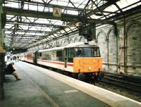 86 258 <I>Talyllyn</I> stands at the head of a WCML train at Waverley's platform 11 in February 1999. The carriages are in Virgin Trains red, but the locomotive is still in BR InterCity livery. The site of the loop line (nearest the wall) is now occupied by Platform 10.<br>
<br><br>[David Panton /02/1999]