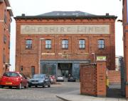 No doubt about which company originally owned this goods shed. The Cheshire Lines Committee, jointly operated by the Great Central, Great Northern and Midland Railways (the names of which are displayed on the south wall). The building dates from 1897 and stands alongside Warrington Central station. However it is no longer in use as a goods shed, having been converted into flats and now going by the name of Barton Court. [See image 34741]<br><br>[John McIntyre 03/03/2010]