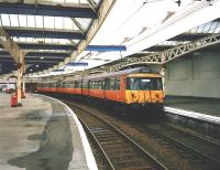 303 058 waits to depart from Gourock for Glasgow Central in July 1997.<br><br>[David Panton /07/1997]