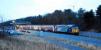 At 17.05 the Workington - Maryport shuttle pauses at Workington North (temporary) station. This station is to the south of the former Siddick Junction. On this occasion the train was top and tailed with 57012 and 37423 <i>Spirit of the Lakes</i>. View looks south-west.<br><br>[Ewan Crawford 01/02/2010]