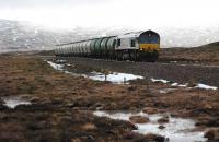 <i>Across the Wasteland</i>: the northbound bauxite and oil tanks for Fort William run north towards Corrour (an hour earlier than scheduled). Viewed from just south of Lubnaclach.<br><br>[Ewan Crawford 15/02/2010]