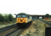 Class 56 No. 56078 runs light engine westwards through Knottingley, heading from the depot that lies immediately to the east of the station. In the background a Pacer that had arrived on a terminating service from Leeds via Castleford waits to drop back into the platform for the return trip. 56078 was taken out of service in May 2007 but after a long period of storage was returned to the main line with Colas in 2014 hauling Chirk bound log trains.<br><br>[Mark Bartlett 22/09/1994]