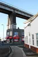 Keyham Viaduct soars over the buildings below. The section of line heading west out of Plymouth crosses several substantial viaducts in quick succession. The view looks north west at the viaduct.<br><br>[Ewan Crawford 20/11/2009]