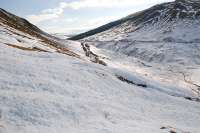 The broken surface of one of the avalanches from above - the view looks towards Tyndrum with Beinn Odhar on the left. The railway is distant centre (and off the the right down a steep slope) and the A82 is on the hillside to the right. I reckoned it was best not to cross this particular avalanche as the snow was very deep and the crust wouldn't hold my weight.<br><br>[Ewan Crawford 08/03/2010]