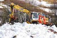 A rail mounted crane and inspection party take a look at one of the avalanches onto the West Highland Railway.<br><br>[Ewan Crawford 08/03/2010]