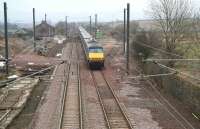 The 0800 <I>East Coast</I> Kings Cross - Edinburgh service runs north through Reston, Berwickshire, on 8 March 2010. The train is passing the site of the island platform once shared by down trains on the main line and local services on the Berwickshire Railway's cross-country line to St Boswells. The station house stands alongside the former main entrance in the left background. Reston, which lost its passenger service in 1964, is one of the locations identified as a possibility for reopening as part of a future improved Edinburgh - Berwick rail service. [See News Item]<br>
<br><br>[John Furnevel 08/03/2010]