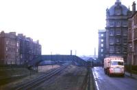 The lorry has just turned north into Connaught Place after leaving the Chancelot Mill in March 1963, passing the footbridge across the railway line into Gosford Place. The line is the Caledonian 'Leith New Lines' route to the Leith eastern docks (singled 14 years after opening) and can be seen through the footbridge crossing the NB North Leith branch just west of Bonnington station [see image 2196].<br><br>[Frank Spaven Collection (Courtesy David Spaven) 25/03/1963]