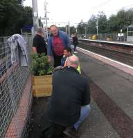 Volunteers at work on one of the platform displays at Carntyne on 7 October 2013. <br><br>[John Yellowlees 07/10/2013]