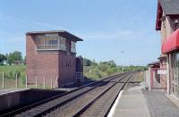 Back in 1989 Auchinleck still retained its signalbox (switched out and windows boarded), goods yard (track in place) and station building. This view looks towards Kilmarnock. The closed branch to the Highhouse Colliery was to the left and behind the camera the former Muirkirk line struck off to the east. The Auchinleck signalbox here was opened in December of 1957 replacing Auchinleck (Station) signalbox at the Kilmarnock end of the station and Gilmilnscroft signalbox at the junction end of the station.<br><br>[Ewan Crawford //1989]