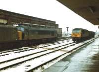 45006 <I>Honourable Artillery Company</I> at Wakefield Kirkgate on a snowy 30 December 1981 with the Heaton - Manchester Red Bank empty newspaper vans, whilst the first loco of the UK class 56 build, 56031, passes with eastbound MGR wagons. Track rationalising has since taken place with the westbound through road between the locos removed, and the former eastbound through road made bi-directional.<br><br>[David Pesterfield 30/12/1981]