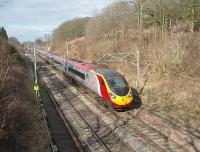 The 1240 Glasgow to Euston Pendolino (390014) is on time as it passes over a permanent way slack at Forton between Bay Horse and Scorton. Engineering possessions resulted in weekend closures between Lancaster and Preston in February and March 2010 and the end marker of another temporary restriction on the down line can also be seen.<br><br>[Mark Bartlett 11/03/2010]