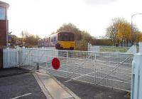 A Clitheroe to Manchester Victoria service, formed by Northern's 150149, passes through closed Daisyfield station as it approaches the junction with the East Lancashire line on the outskirts of Blackburn. The signal box here is still open but the level crossing gates are operated by hand. <br><br>[Mark Bartlett 17/11/2009]